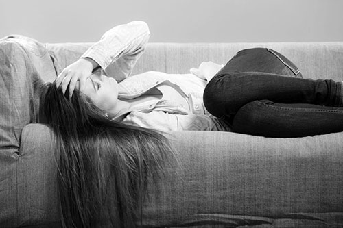 woman in pain on lounge